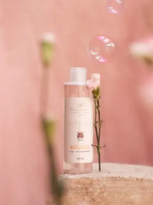 Flacon de lotion nettoyante naturelle sur fond rose